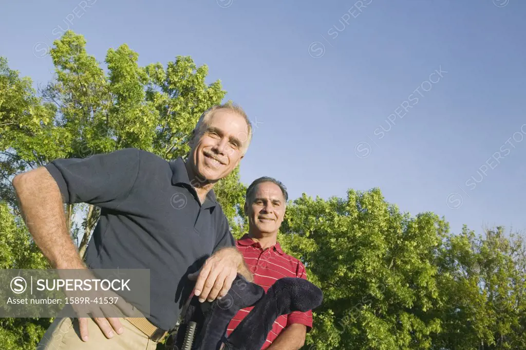 Hispanic men with golf clubs