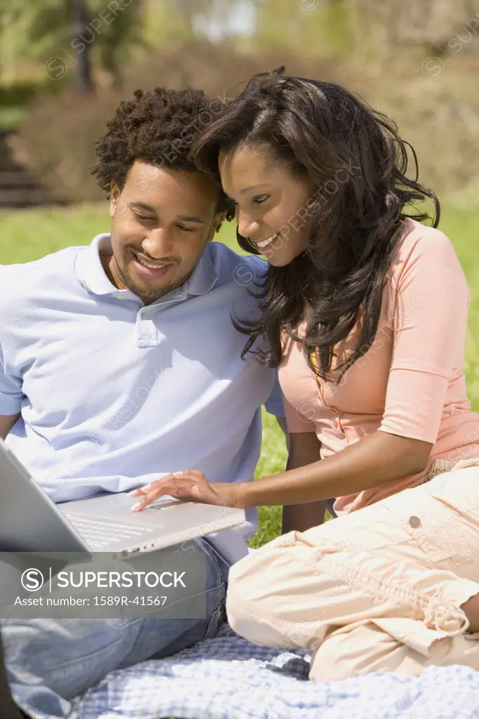 African American couple looking at laptop