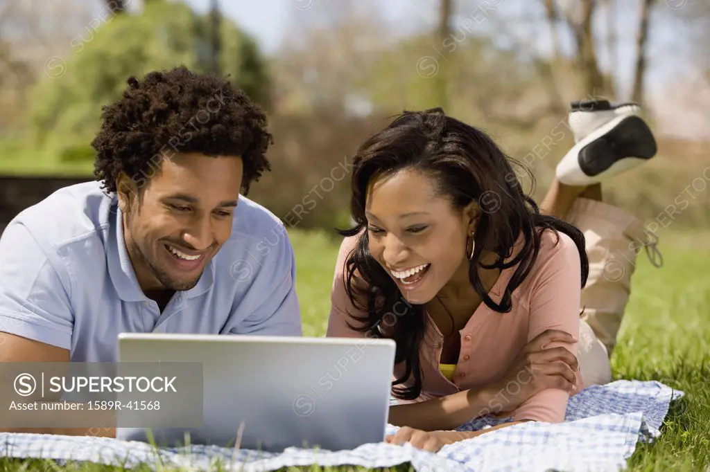 African American couple looking at laptop