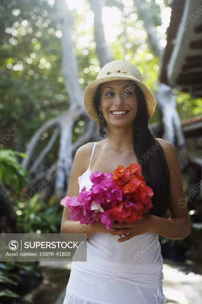 South American woman carrying bouquet of flowers
