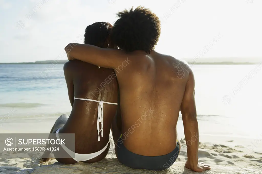 South American couple hugging at beach