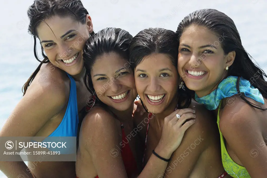 South American women hugging at beach