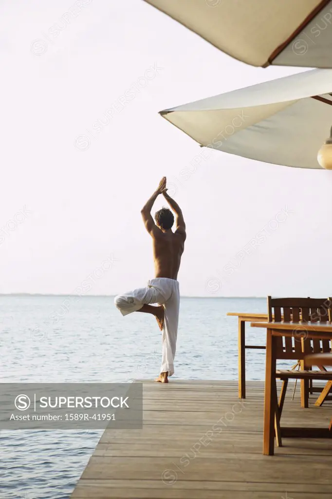 South American man practicing yoga