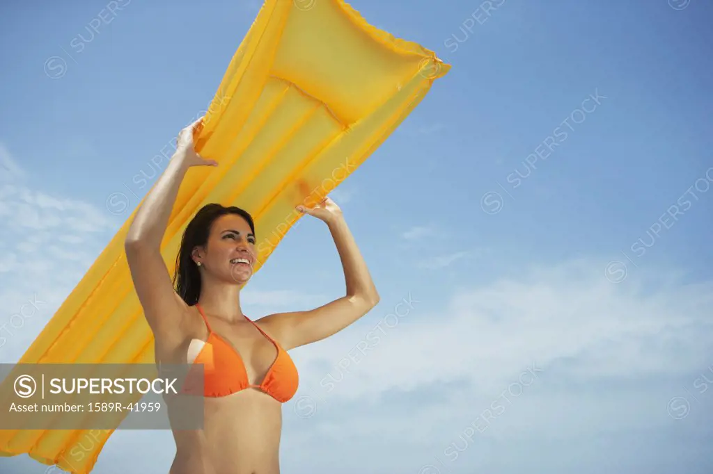 South American woman holding raft