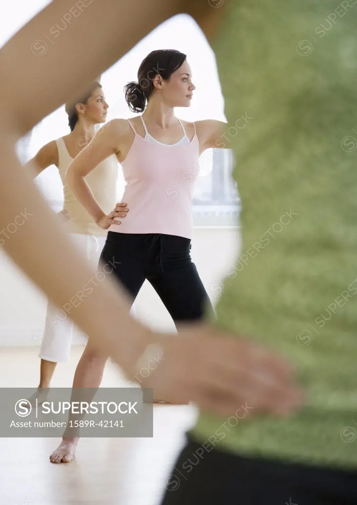 Three young women in yoga class