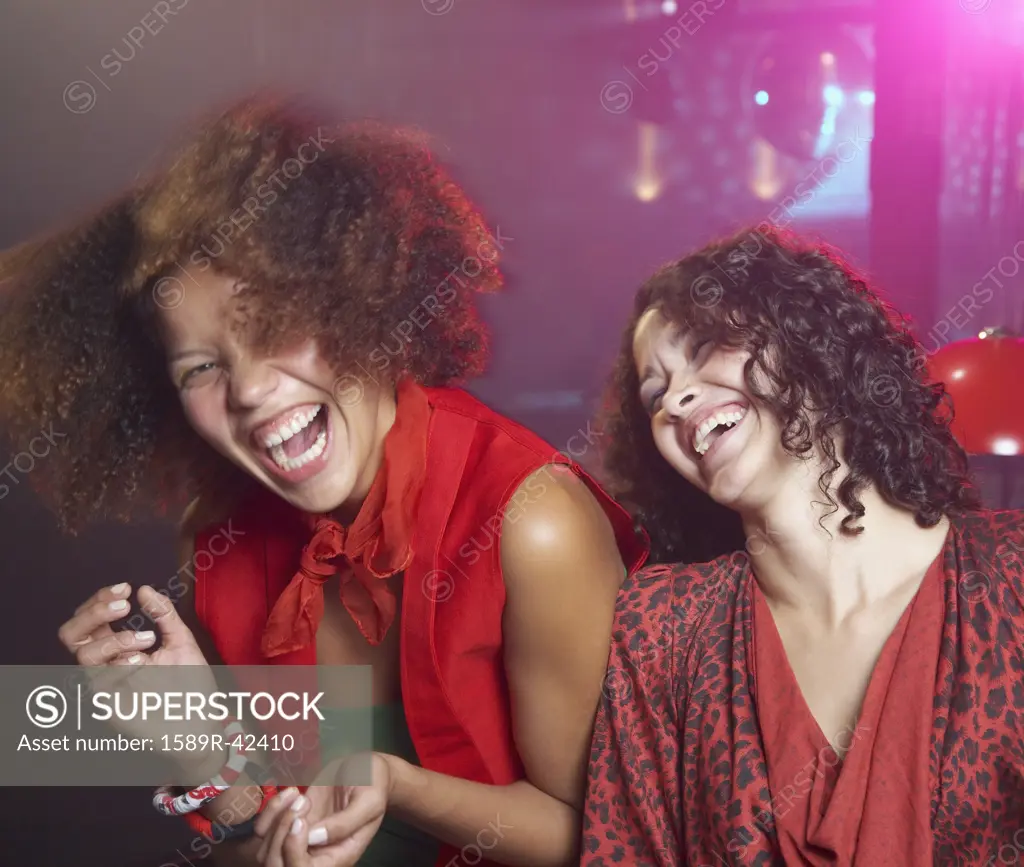 Hispanic women laughing at nightclub