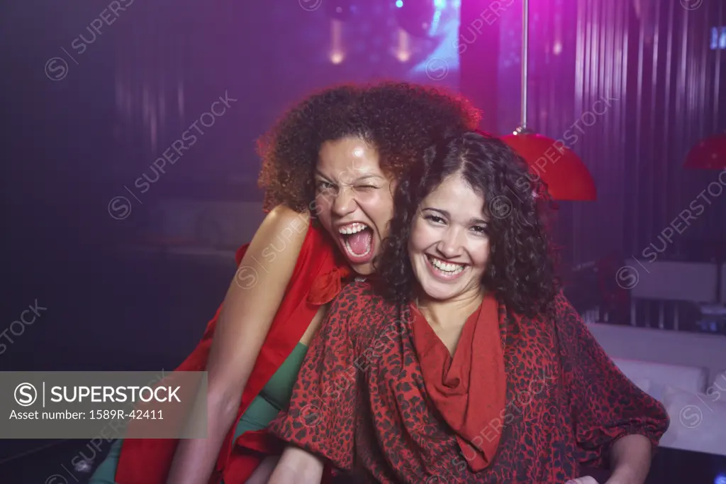 Hispanic women laughing at nightclub