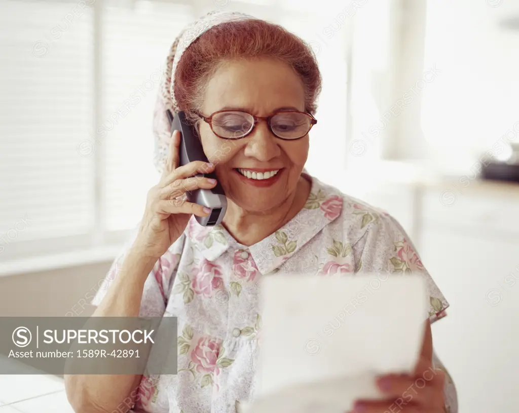 Senior Hispanic woman talking on telephone