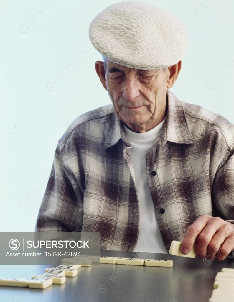 Senior Hispanic man playing dominoes