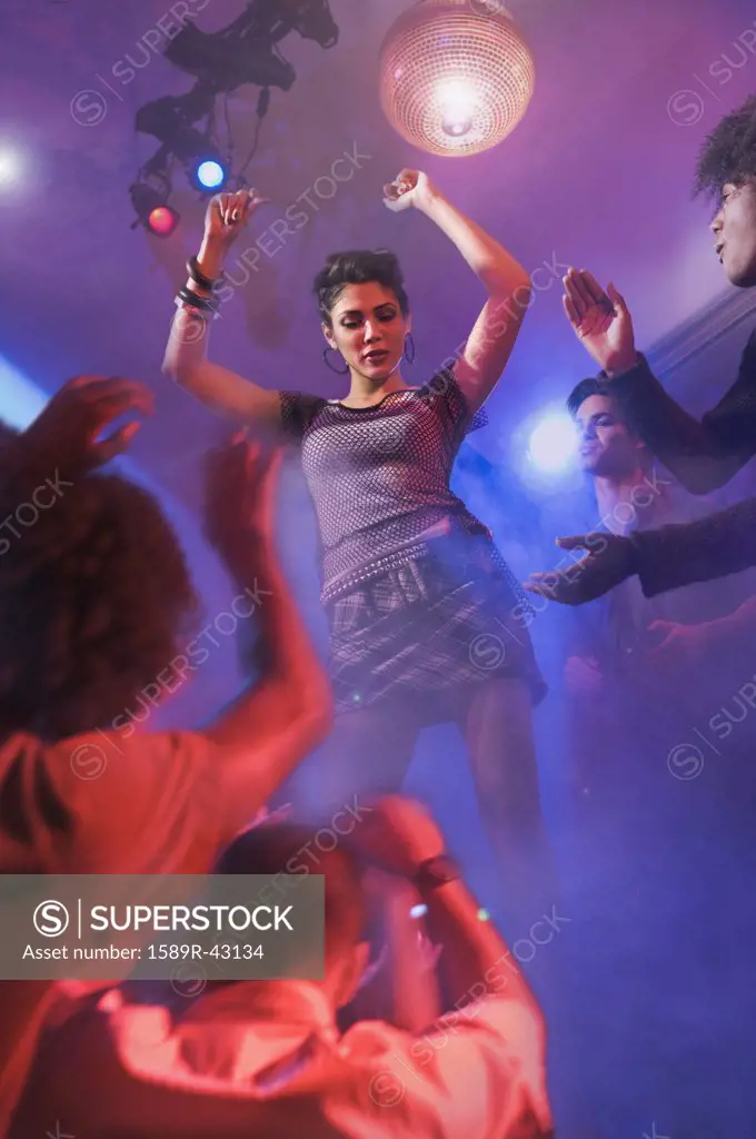 Asian woman dancing at nightclub