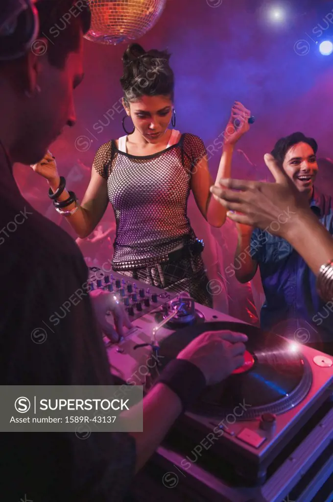 Hispanic dj playing at nightclub