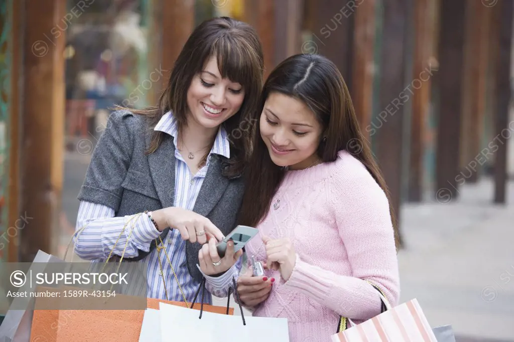 Two Hispanic women looking at cell phone
