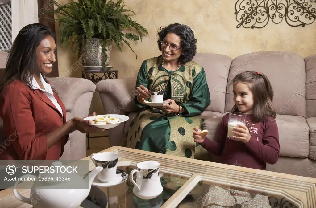 Multi-generational Indian female family members having snack