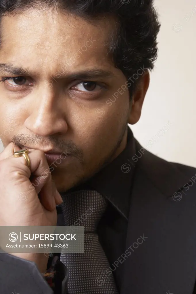 Indian businessman making face