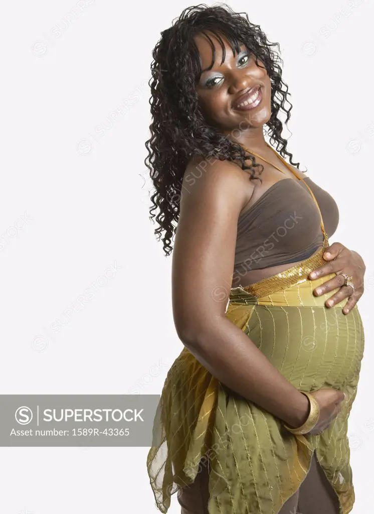 Pregnant African American woman with hands on belly