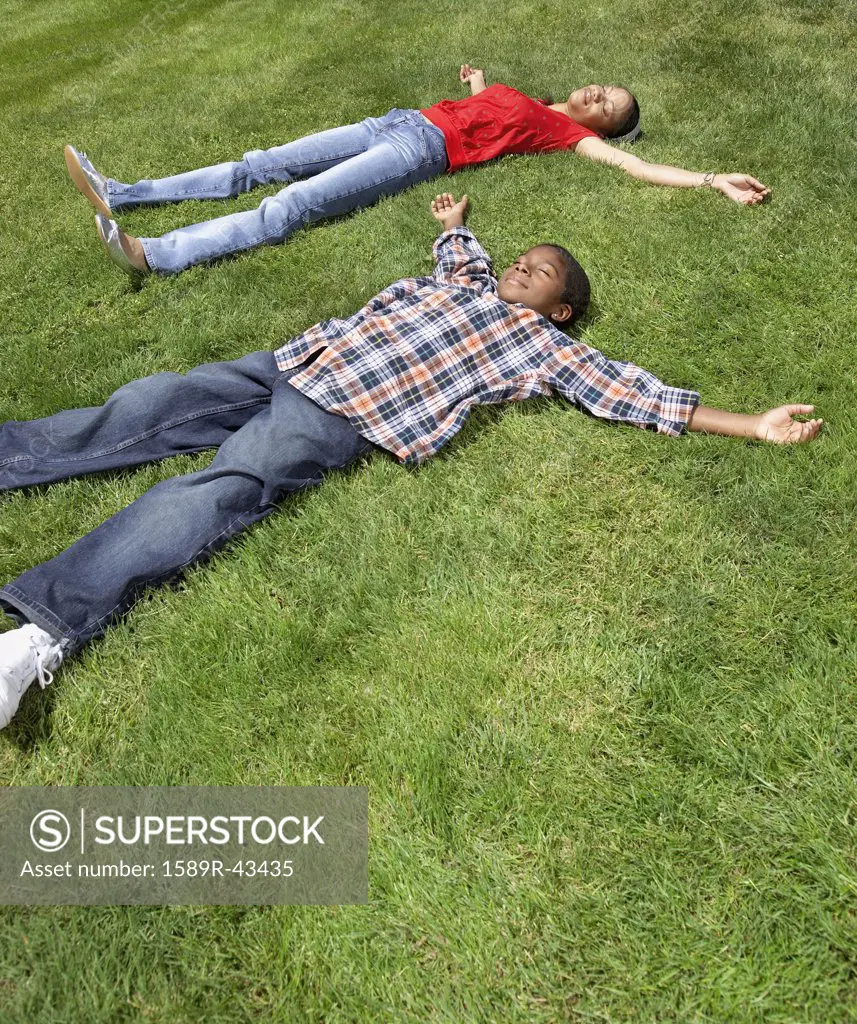 African mother and son laying in grass