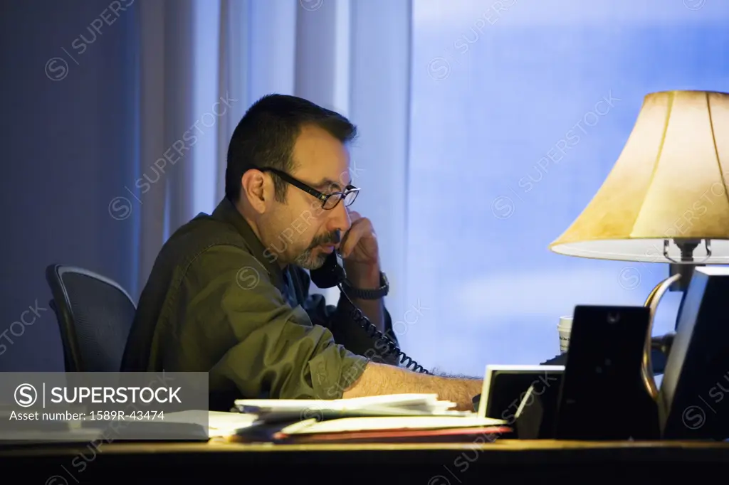 Hispanic businessman talking on telephone