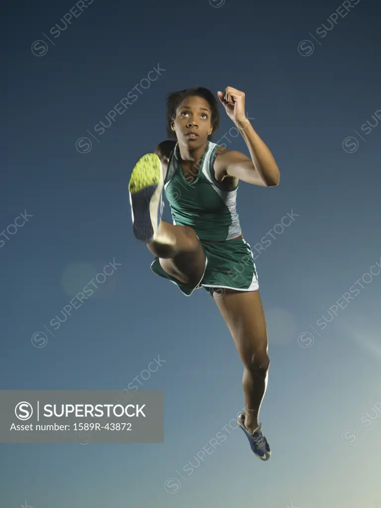 African American female athlete jumping