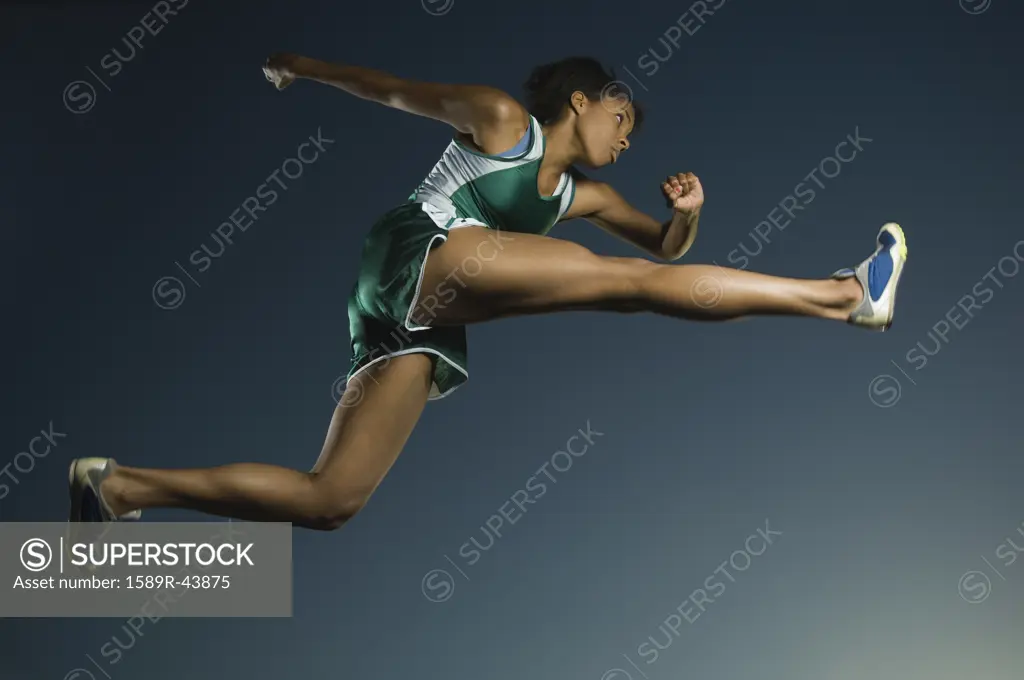 African American female athlete jumping