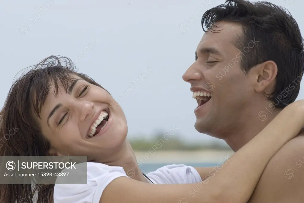 Multi-ethnic couple laughing