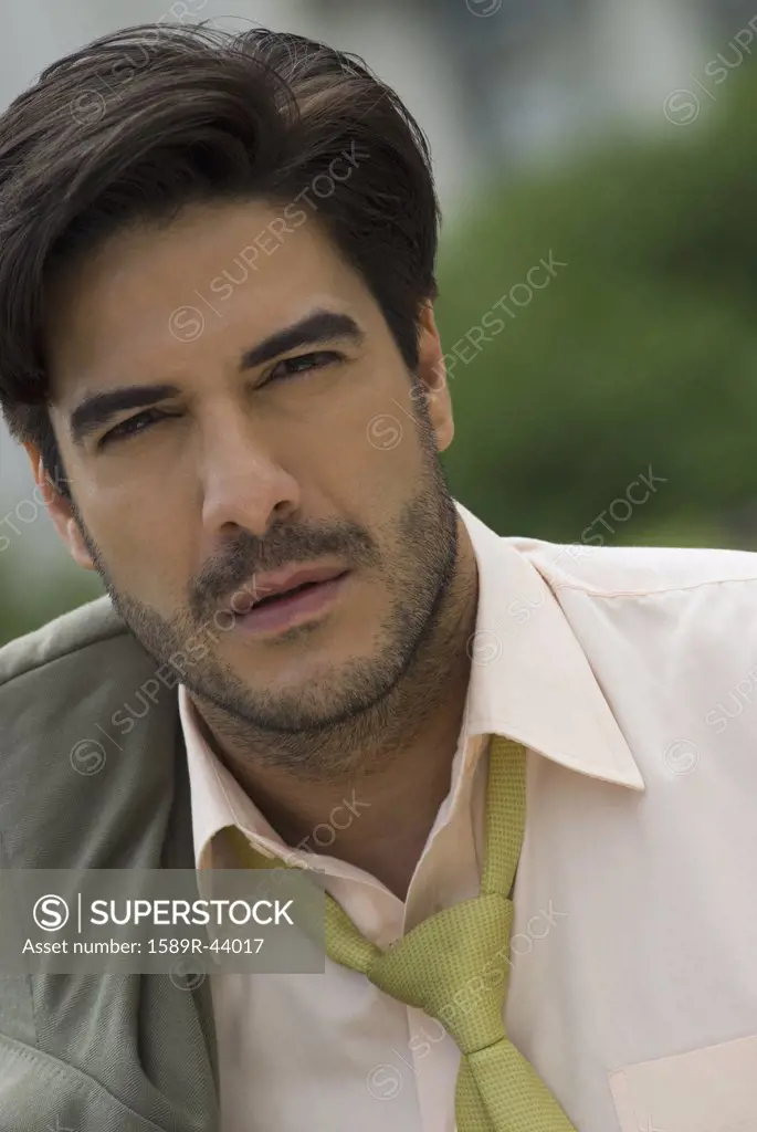 Hispanic businessman with jacket over shoulder