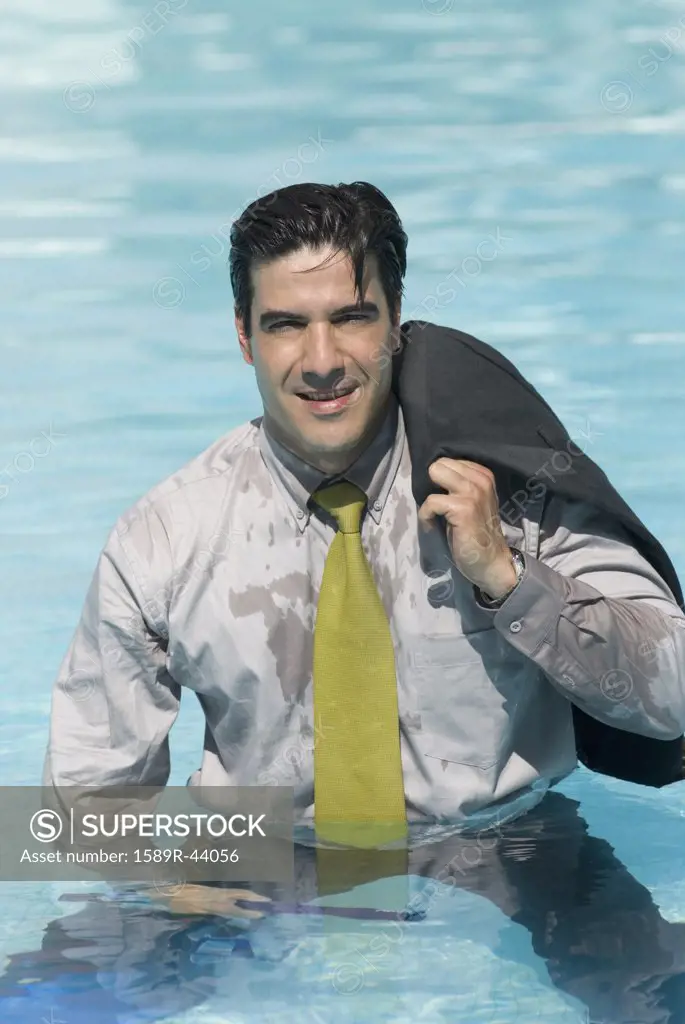 Hispanic businessman in swimming pool