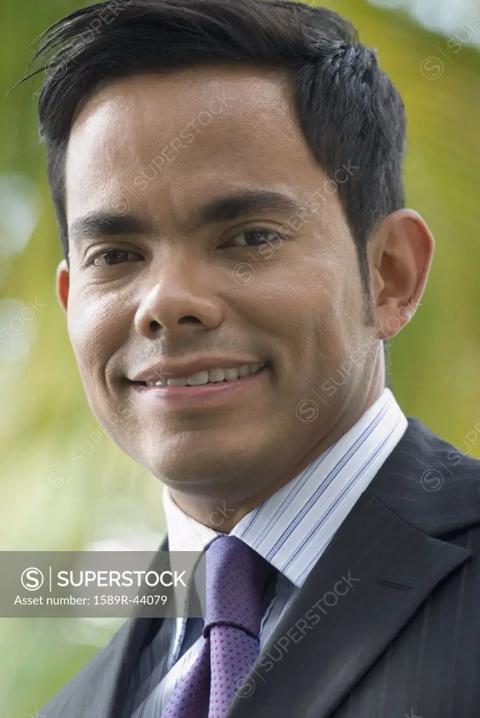 Close up of Hispanic businessman smiling