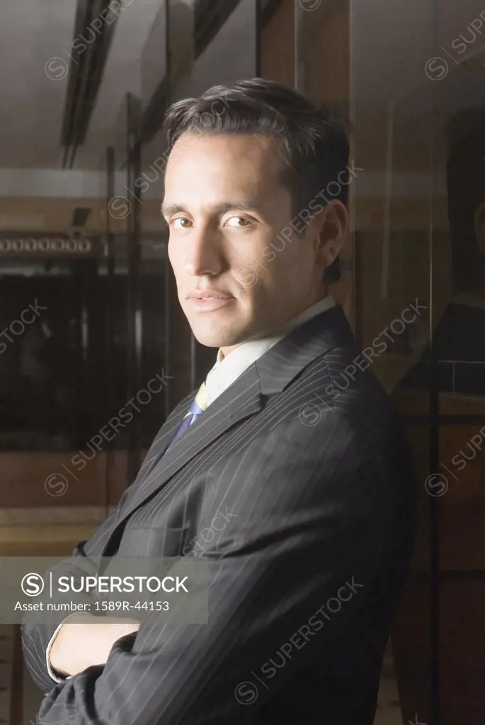 Hispanic businessman with arms crossed