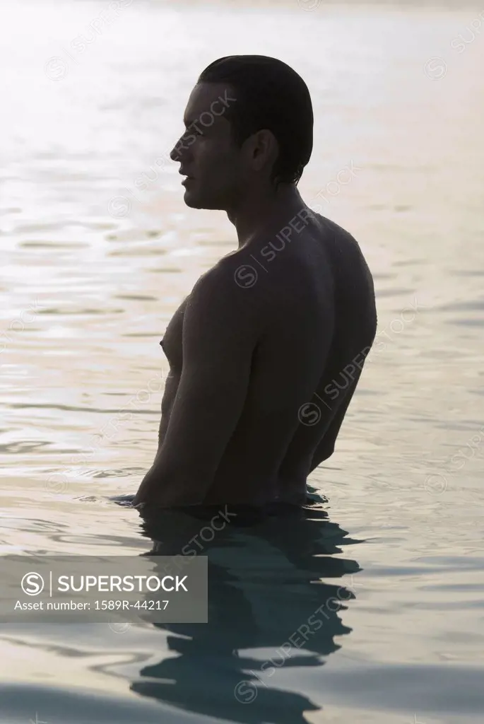 Hispanic man standing in water