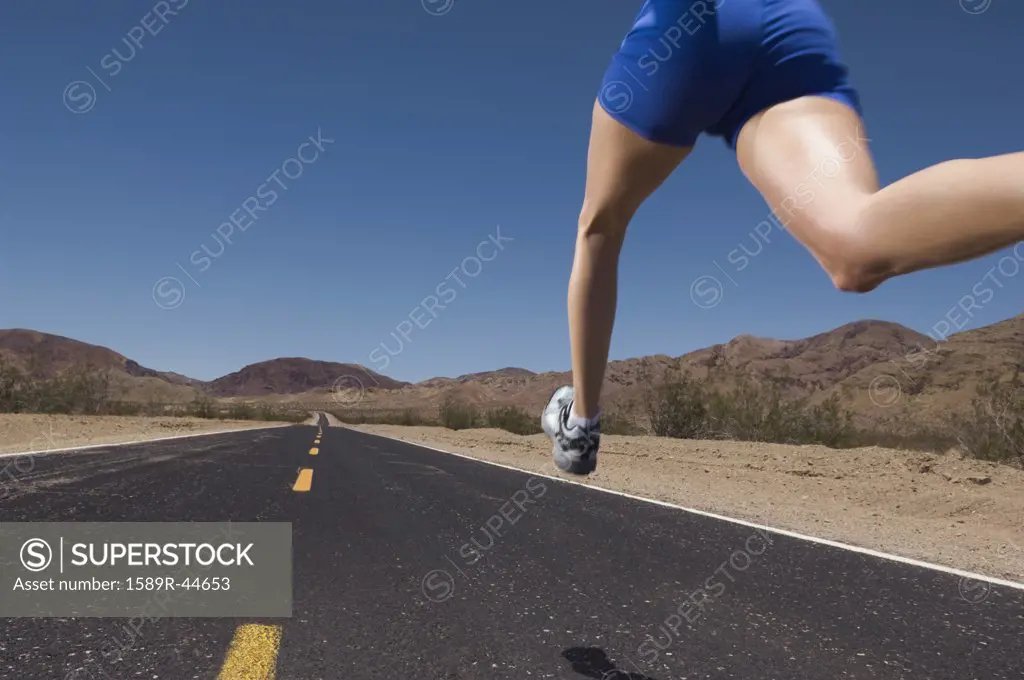 Mixed Race woman running on road