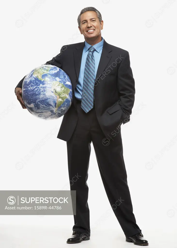 Hispanic businessman holding globe