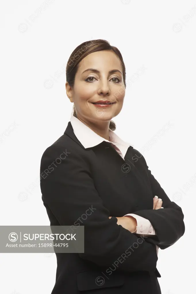 Hispanic businesswoman with arms crossed