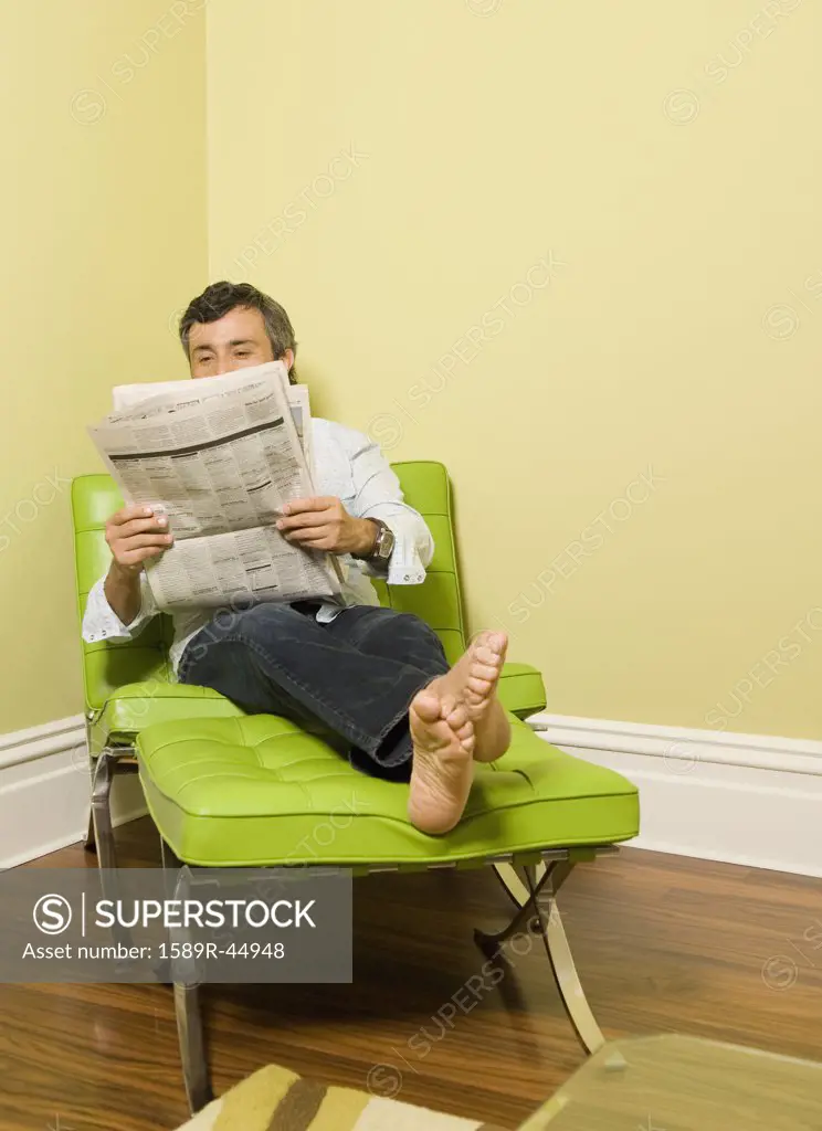 Hispanic man reading newspaper