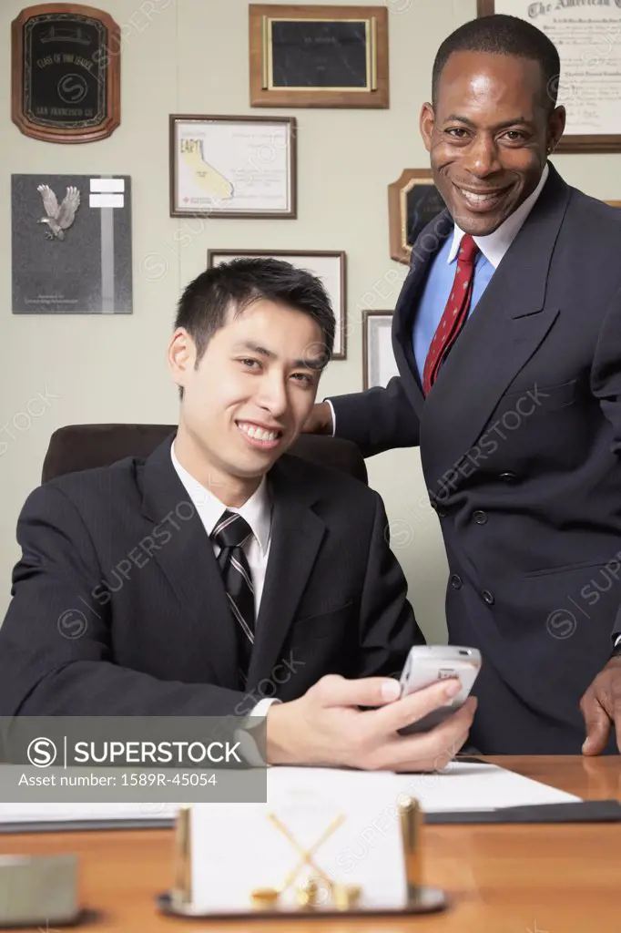 Multi-ethnic businessmen behind desk