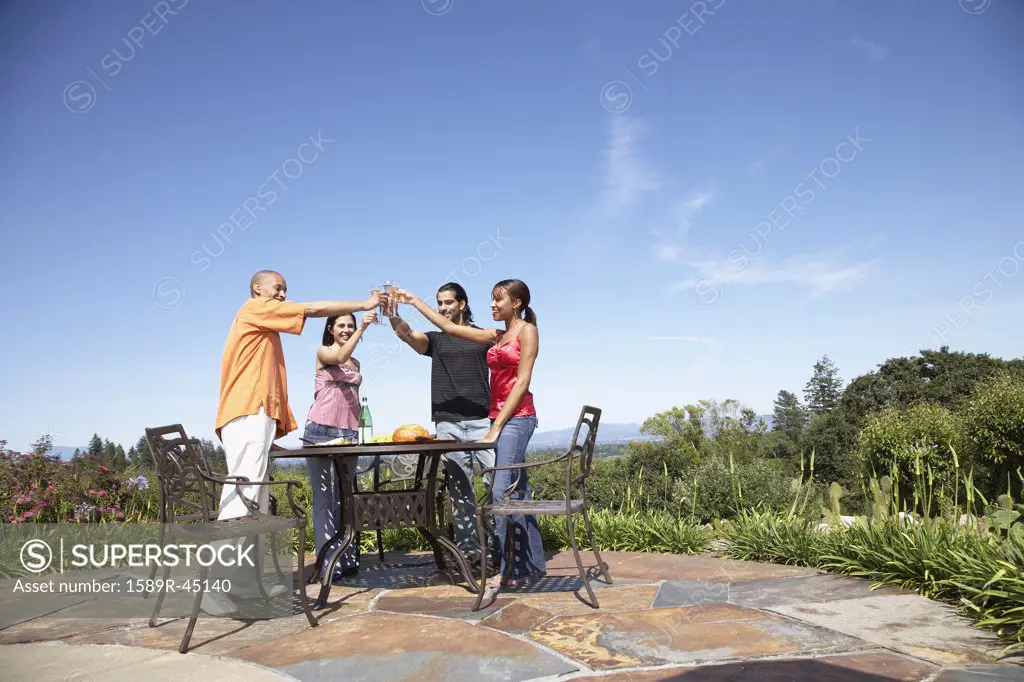 Multi-ethnic couples toasting outdoors