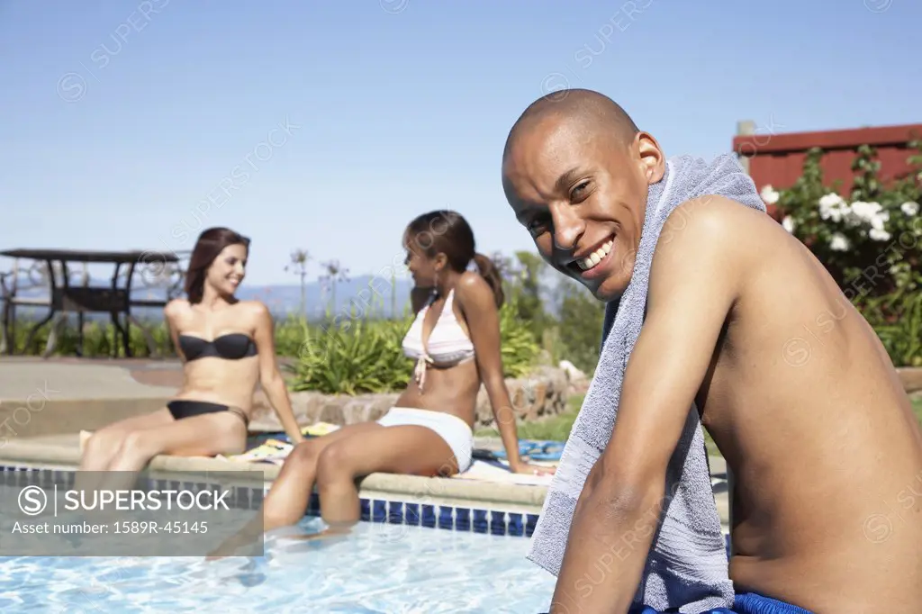 African man next to swimming pool