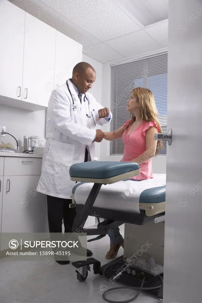 African American male doctor examining patient