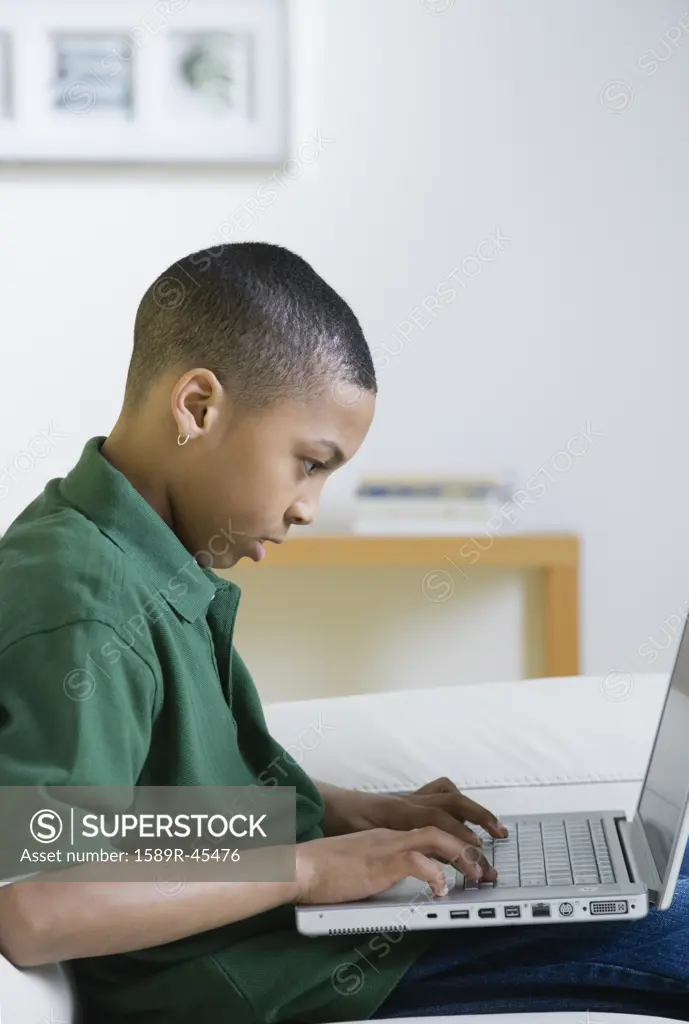 African American boy typing on laptop