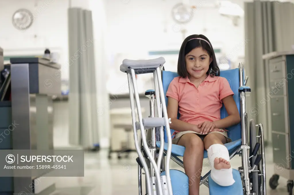 Hispanic girl with cast in wheelchair