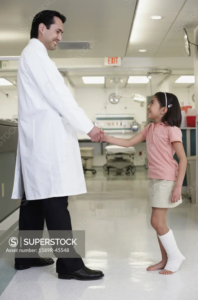 Hispanic girl shaking hands with doctor