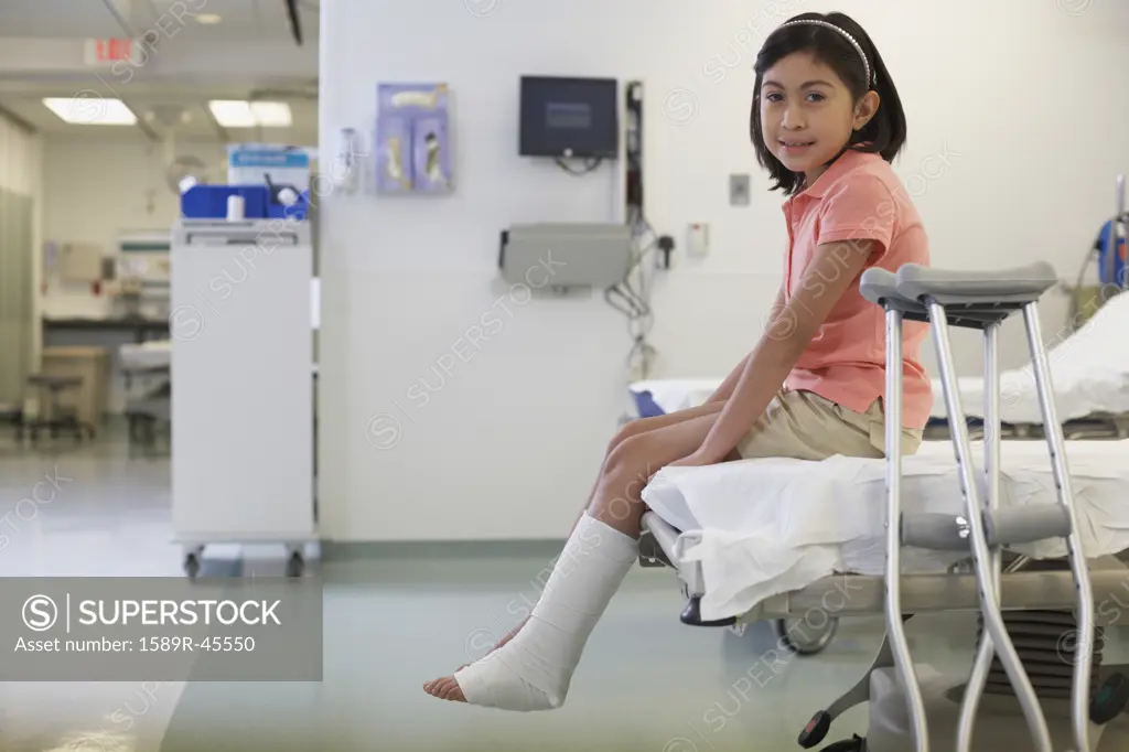 Hispanic girl with cast in hospital