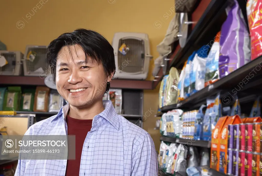 Asian man in pet store