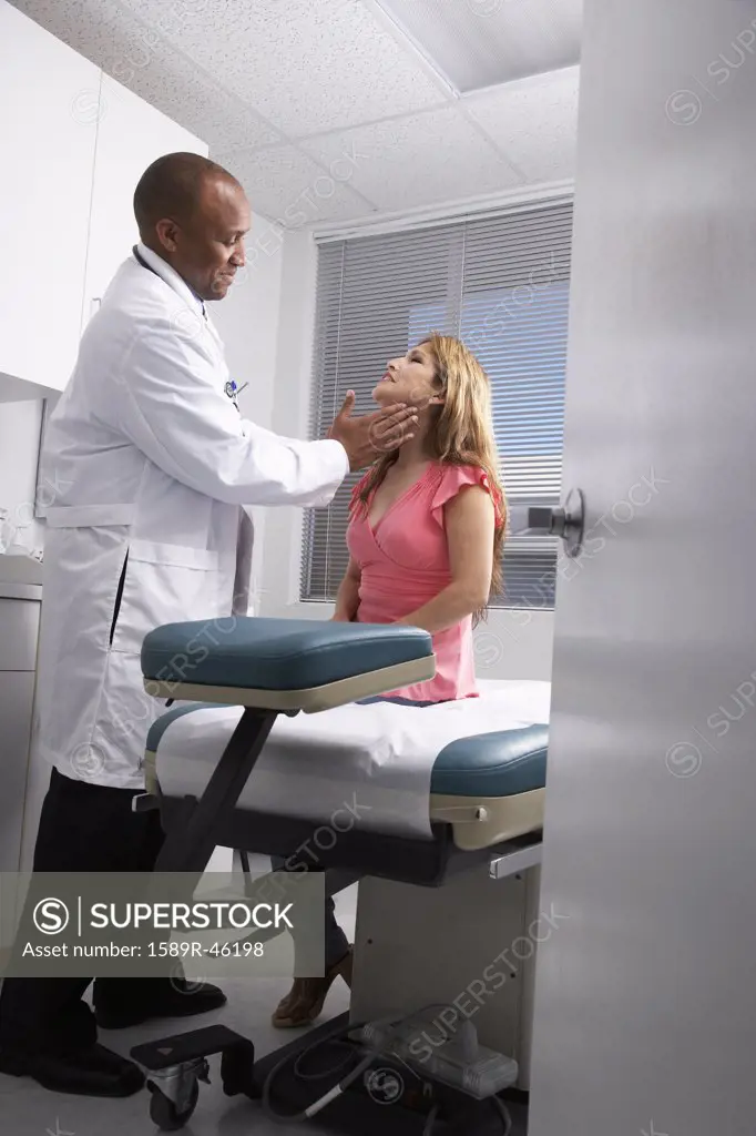 African American male doctor examining patient