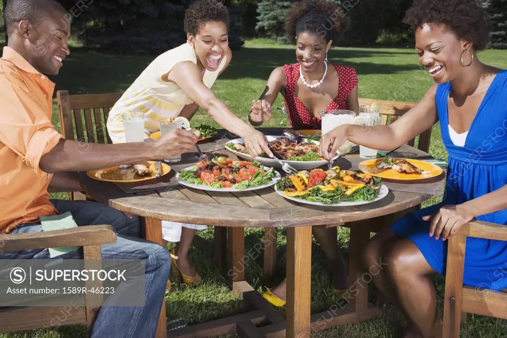 African American friends eating outdoors