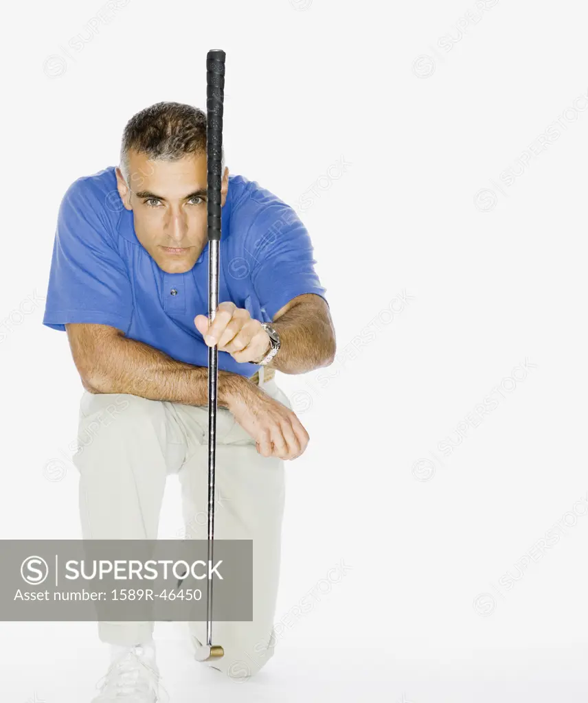 Middle Eastern man holding golf club