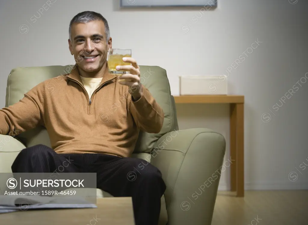 Middle Eastern man holding up drink