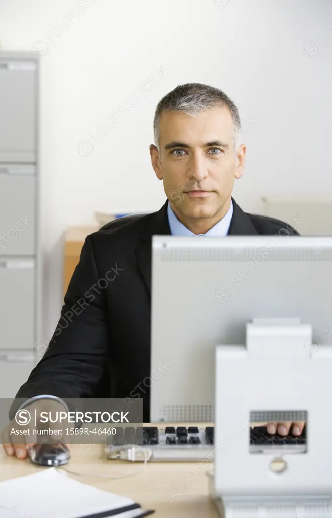 Middle Eastern businessman sitting at desk