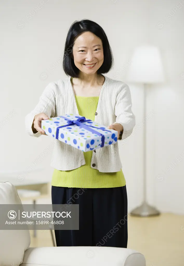 Asian woman holding gift