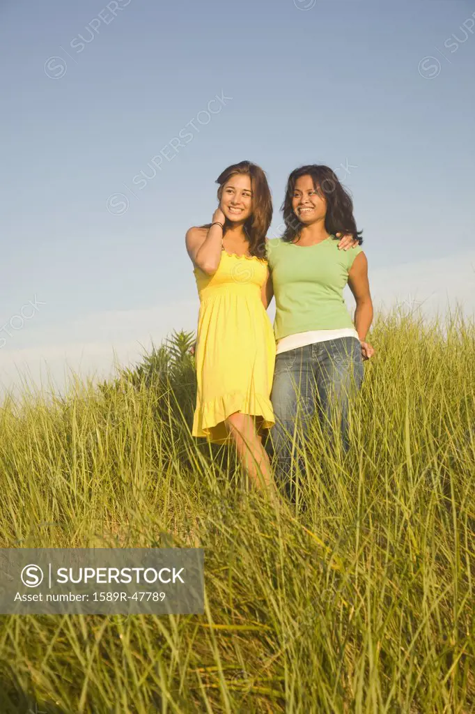 Asian mother and daughter in dune grass