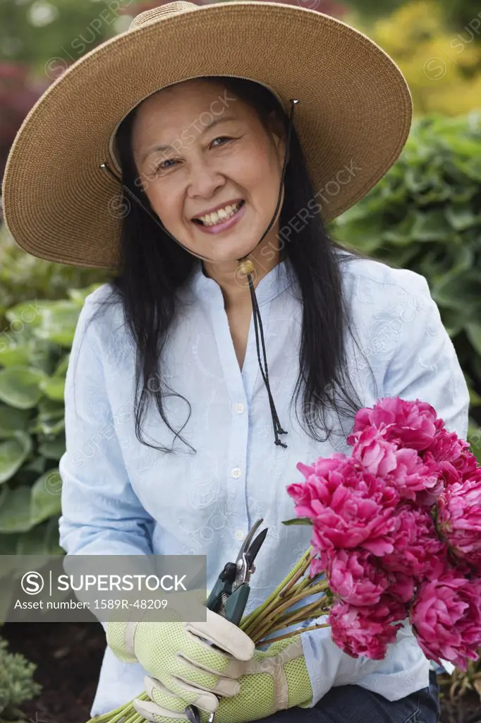 Senior Asian woman holding flowers